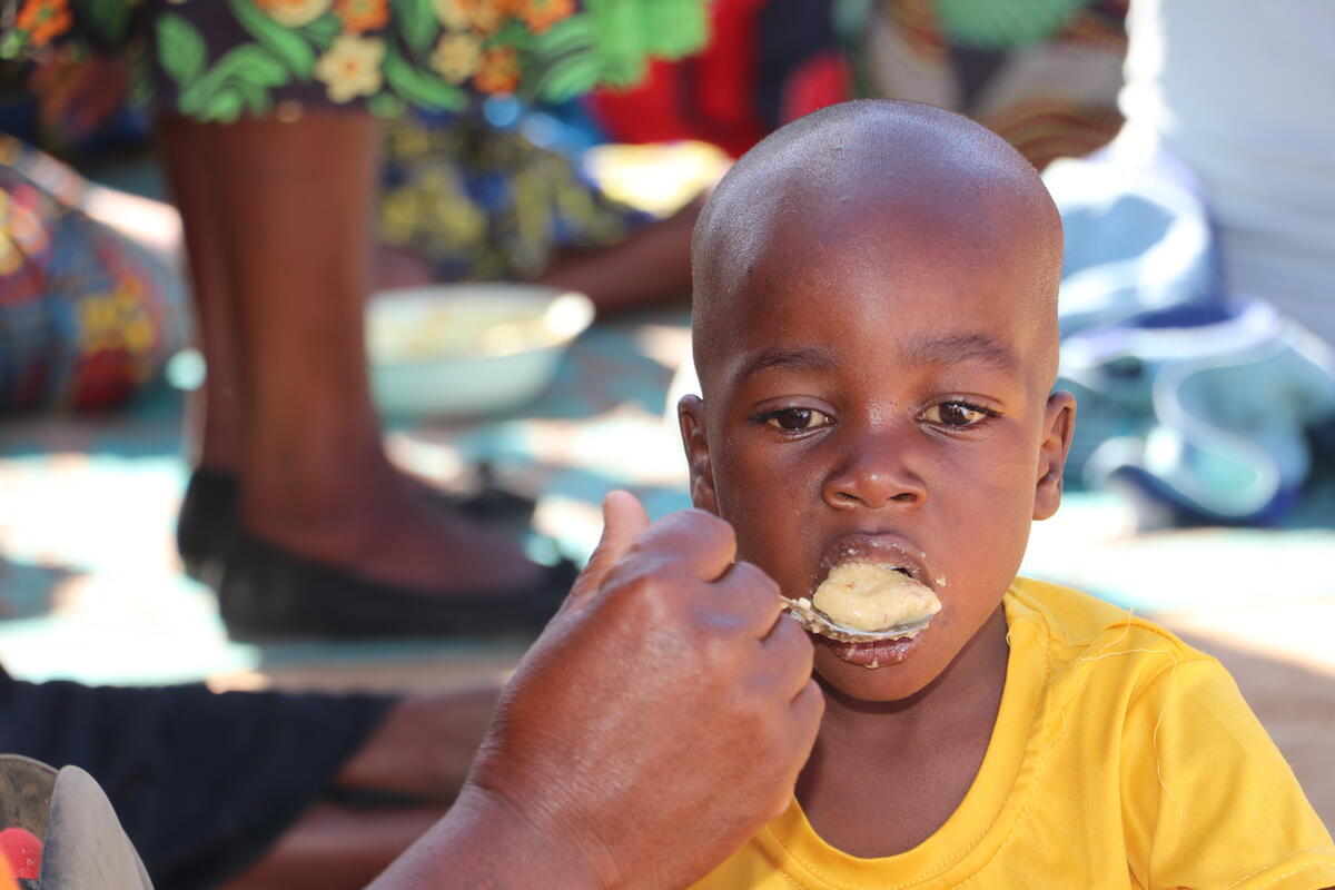 A boy child being spoon fed.