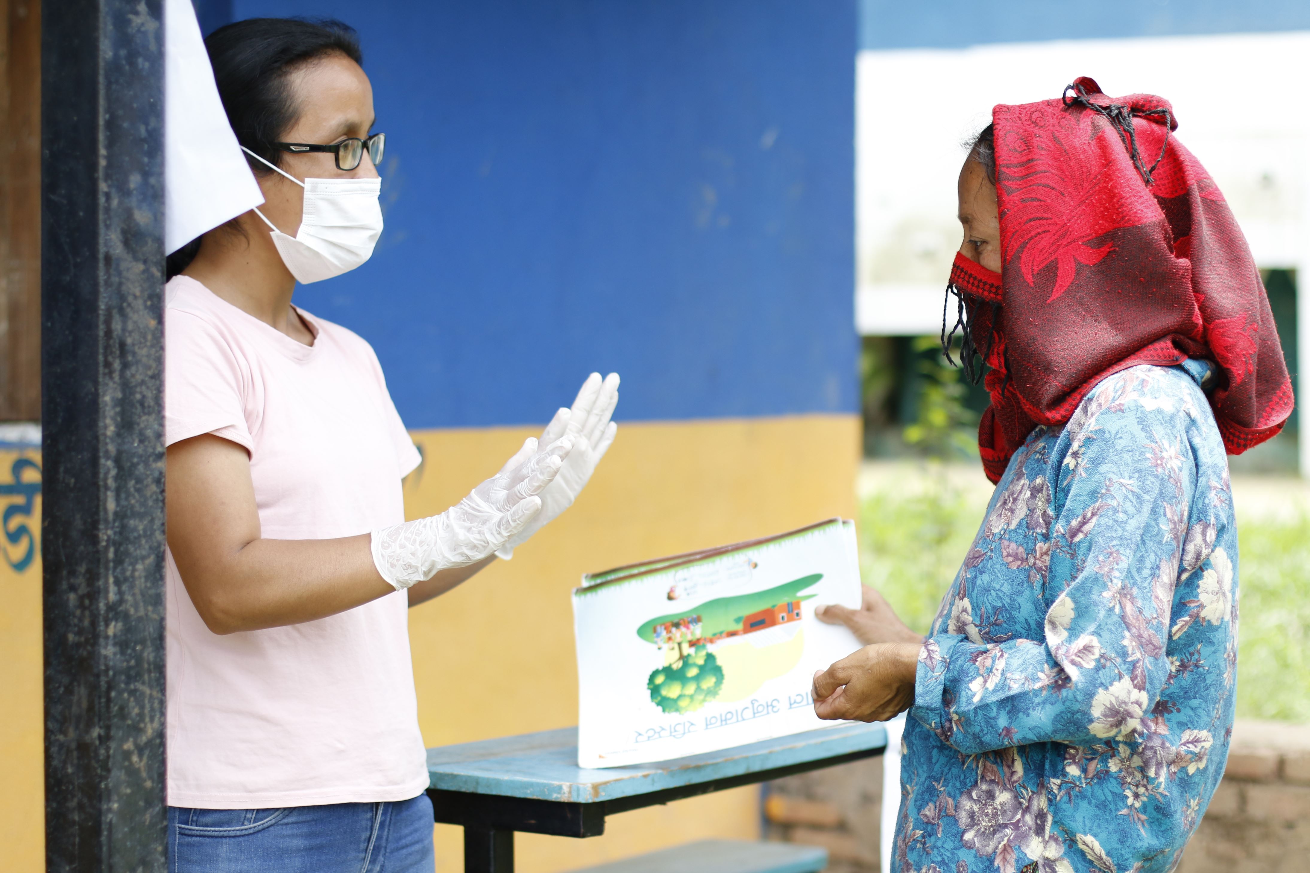 Two health workers talking to each other