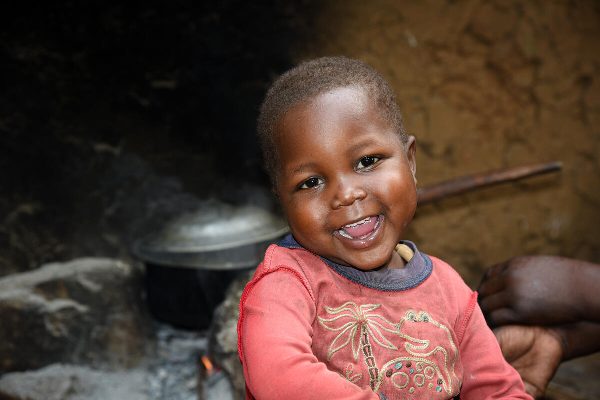 Four-year-old child from DRC looks into the camera and smiles