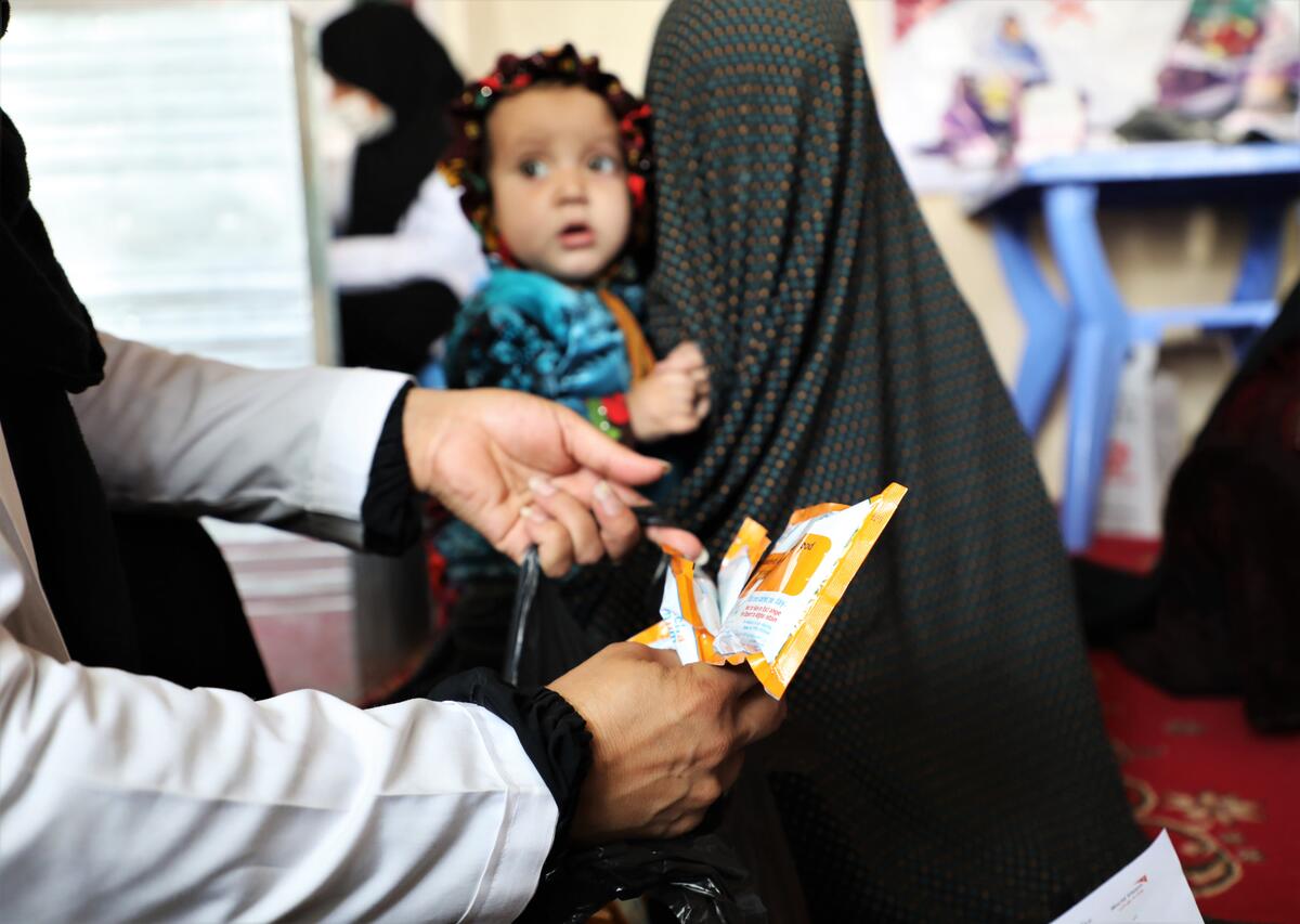Mother and child being provided with vital food assistance.