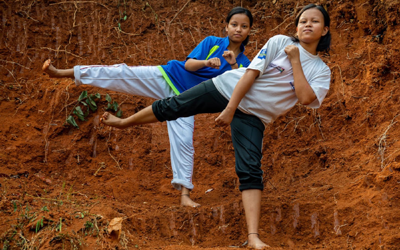 Two girls demonstrate the karate moves they learnt