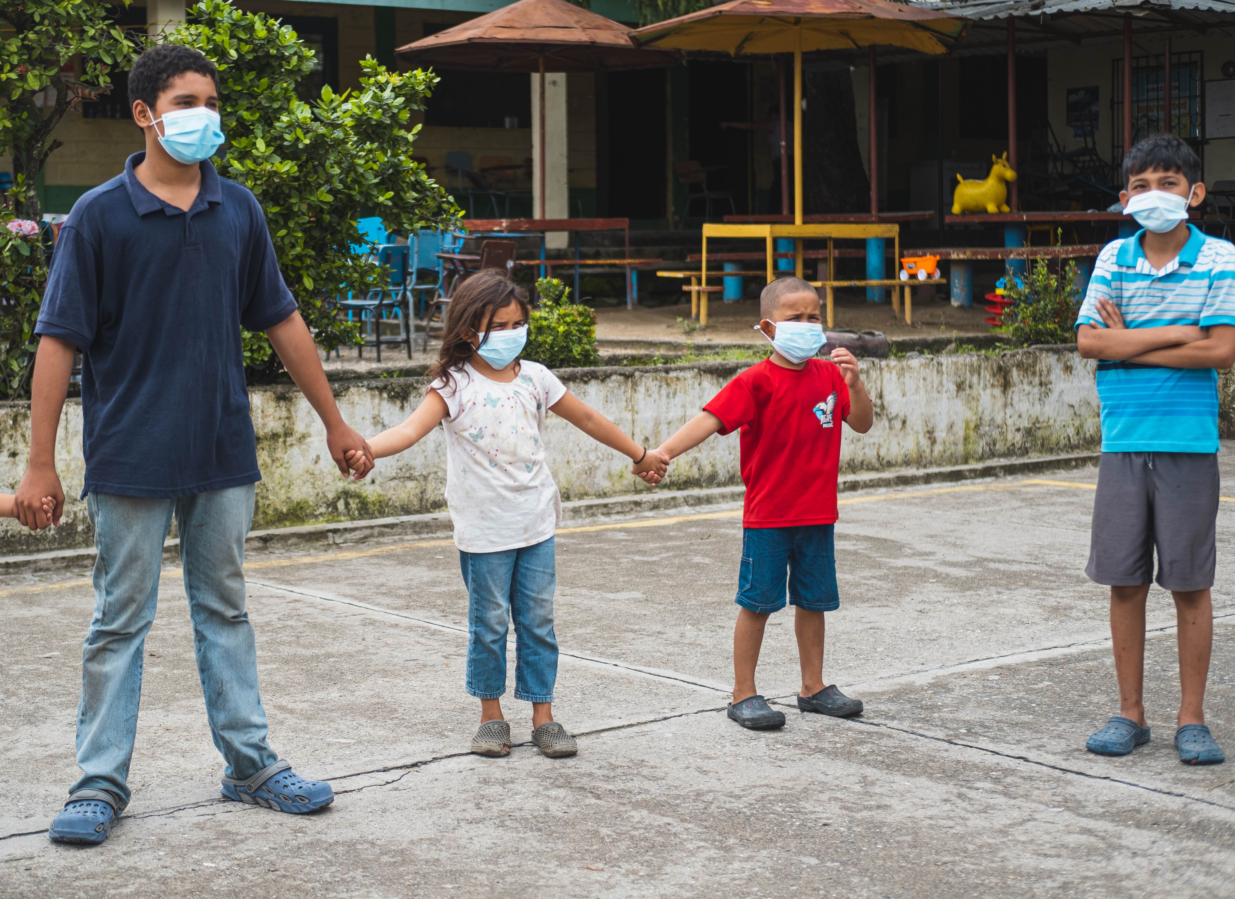 Omar and his older sister taking part in an activity at a child friendly space.