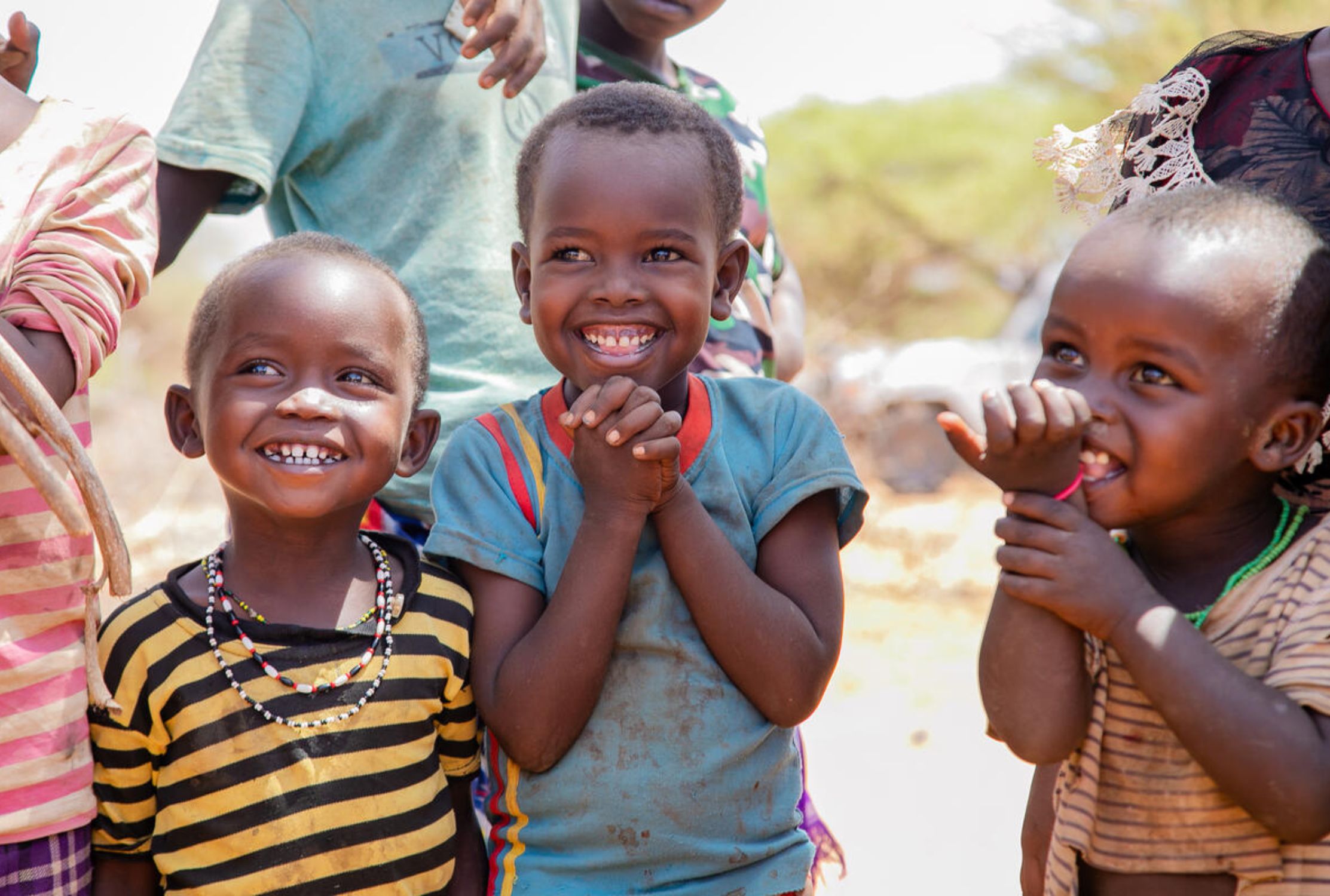 Three young Kenyan children smiling