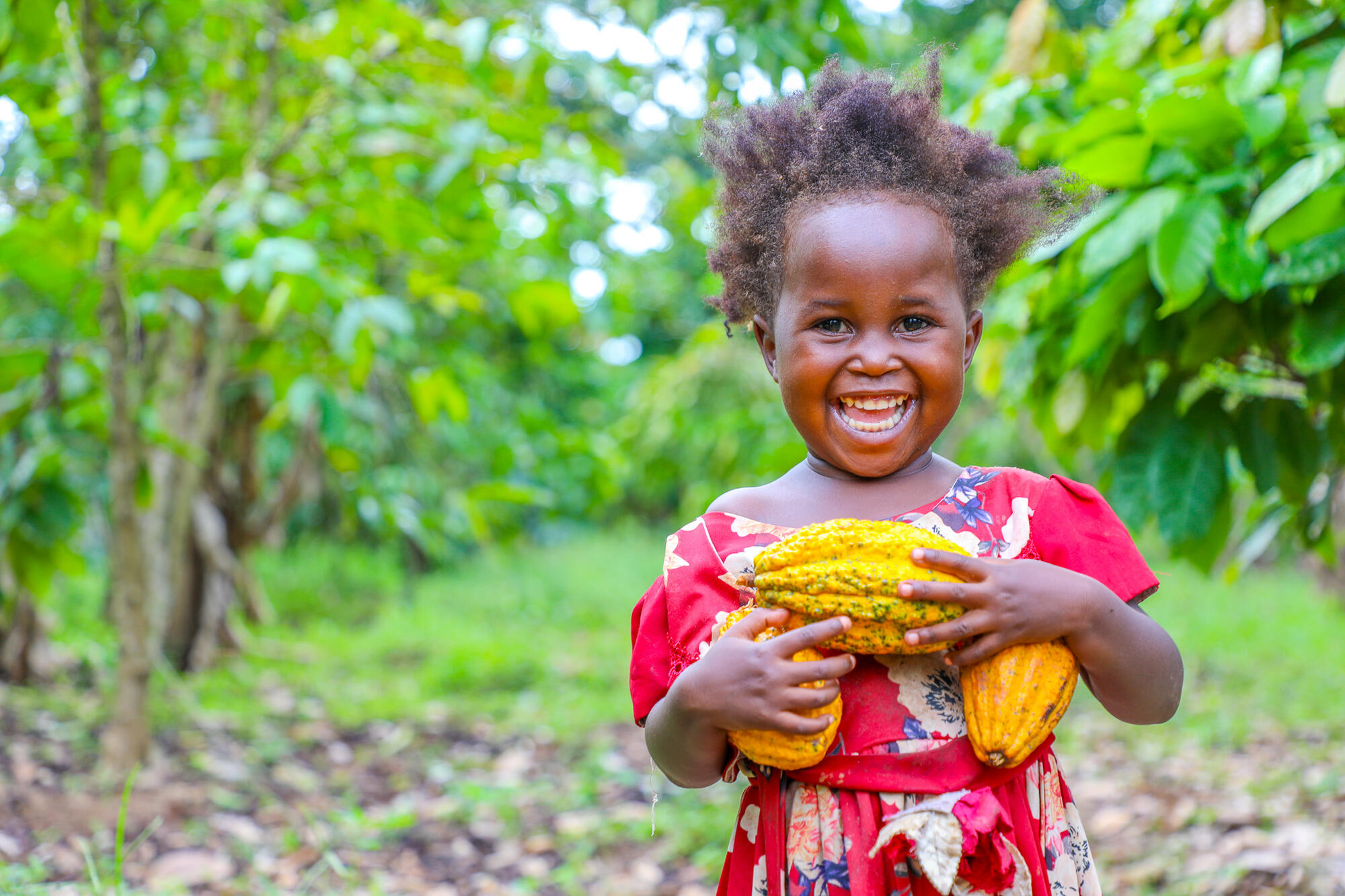A young girl from Uganda smiles to the camera
