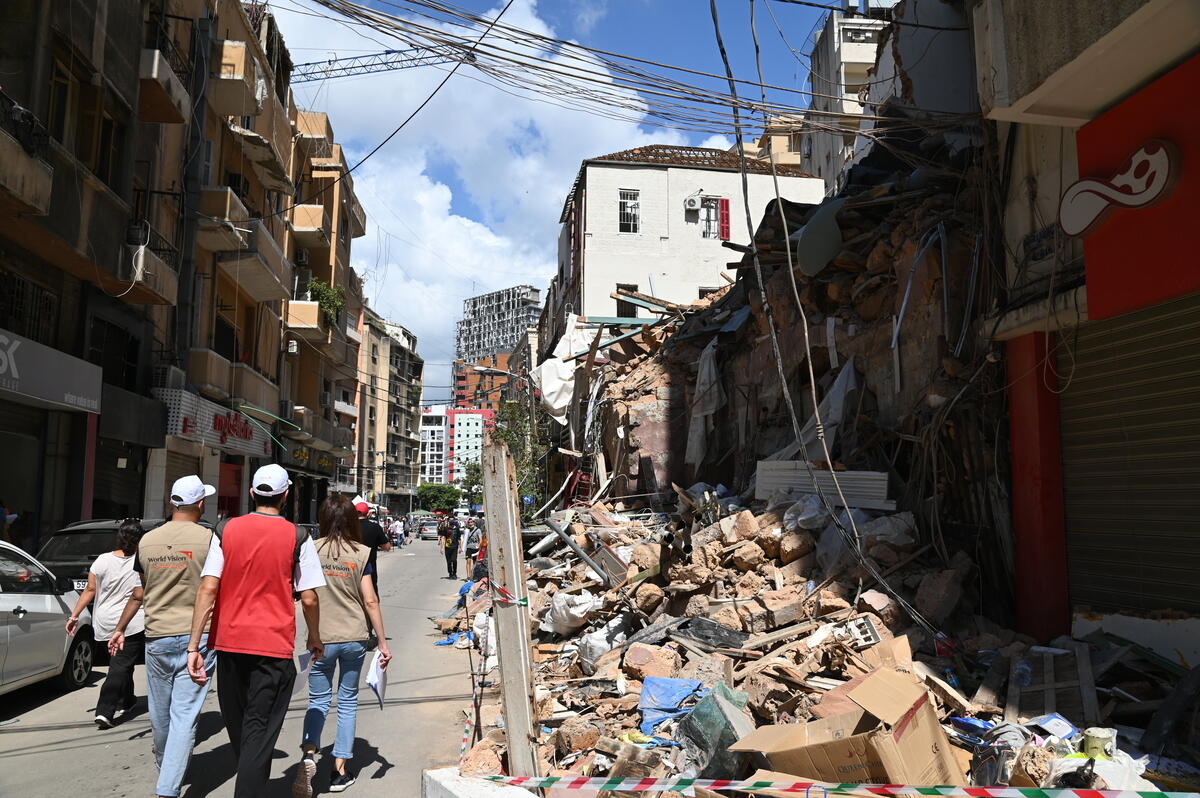 World Vision staff walk past rubble caused by the 2020 Beirut explosion
