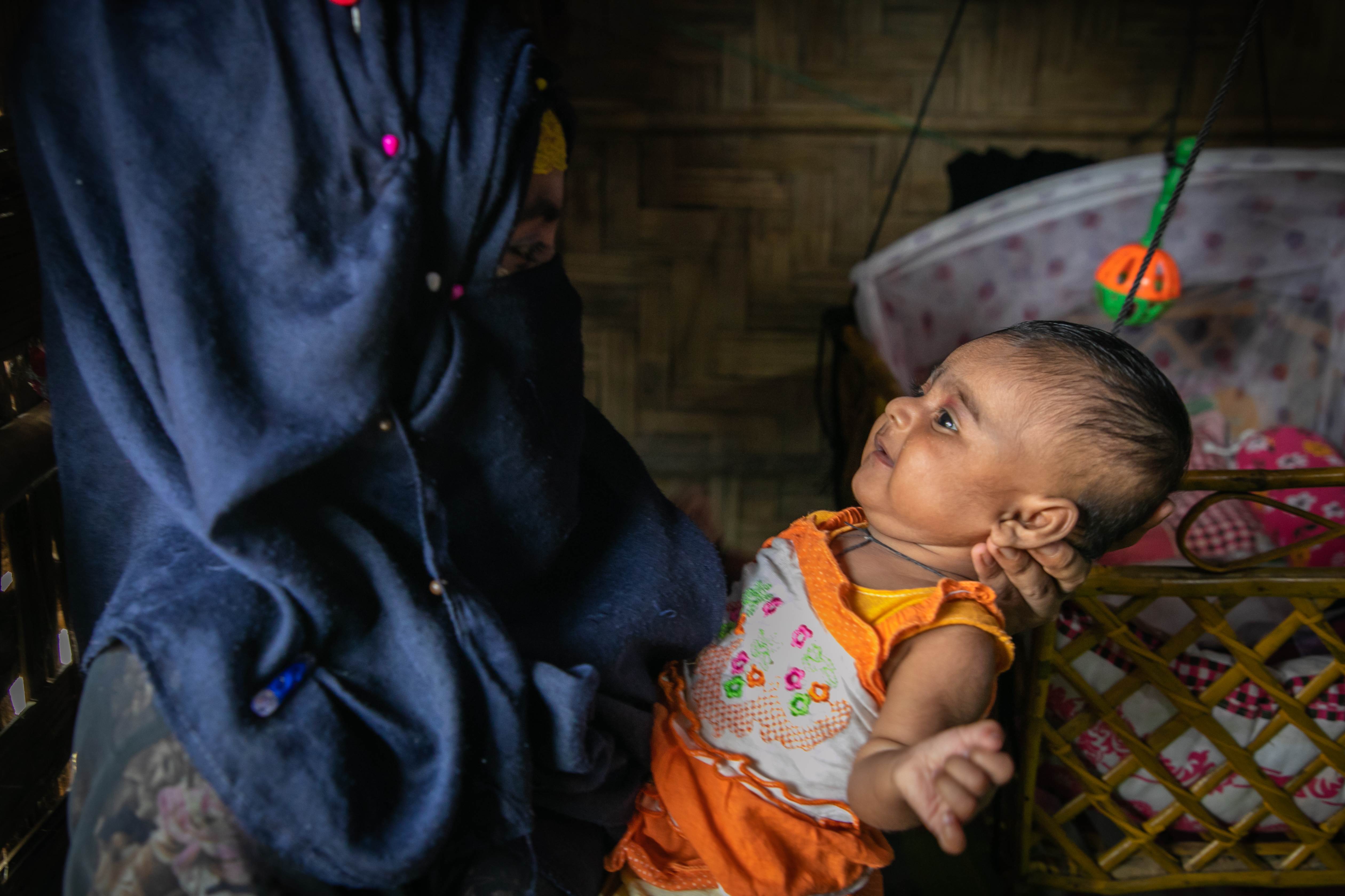A baby looking at her mother.