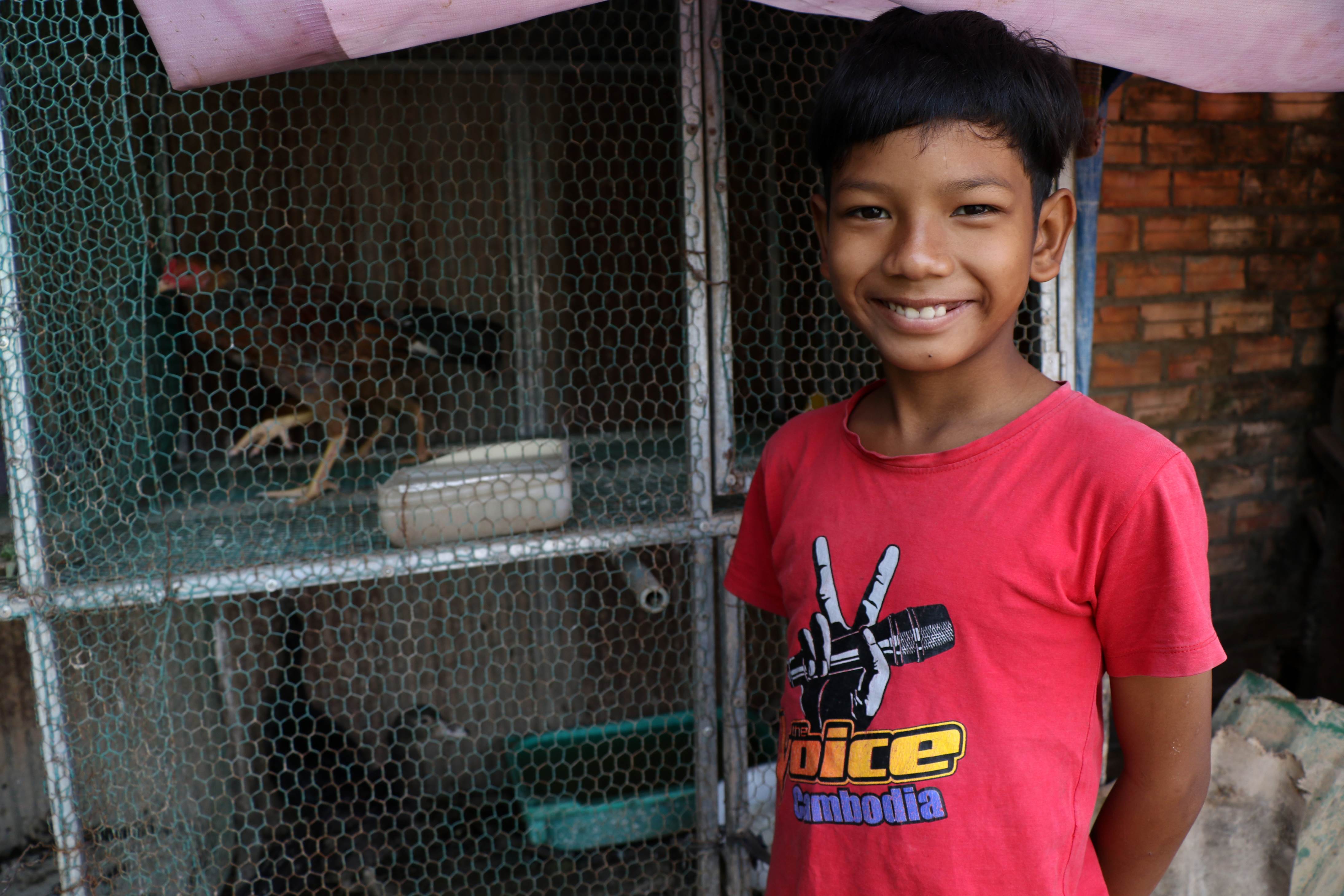 A sponsored child is enjoying looking after and raising the chicken in Cambodia