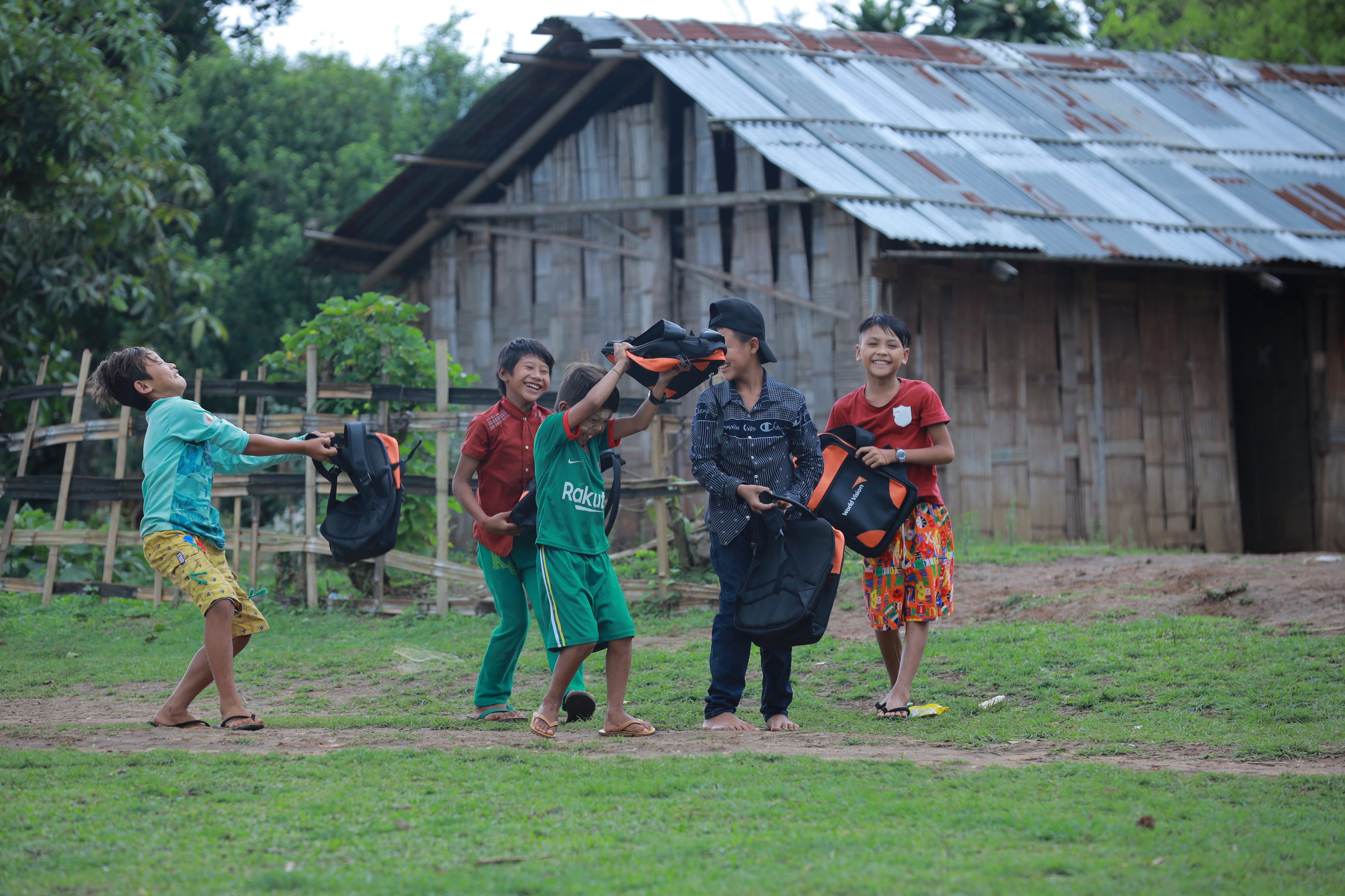 A group of children from Myanmar playing outside their school