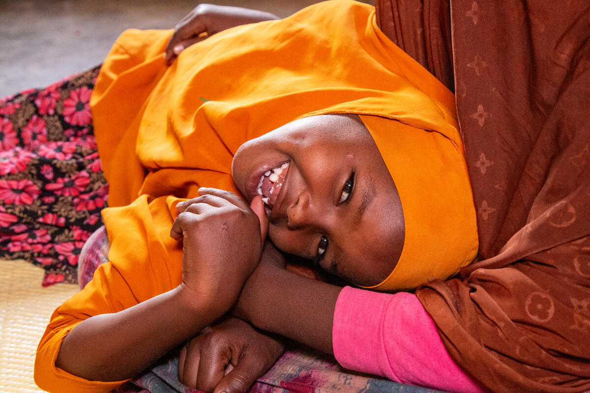 A dimpled girl smiles at the camera, Somalia.