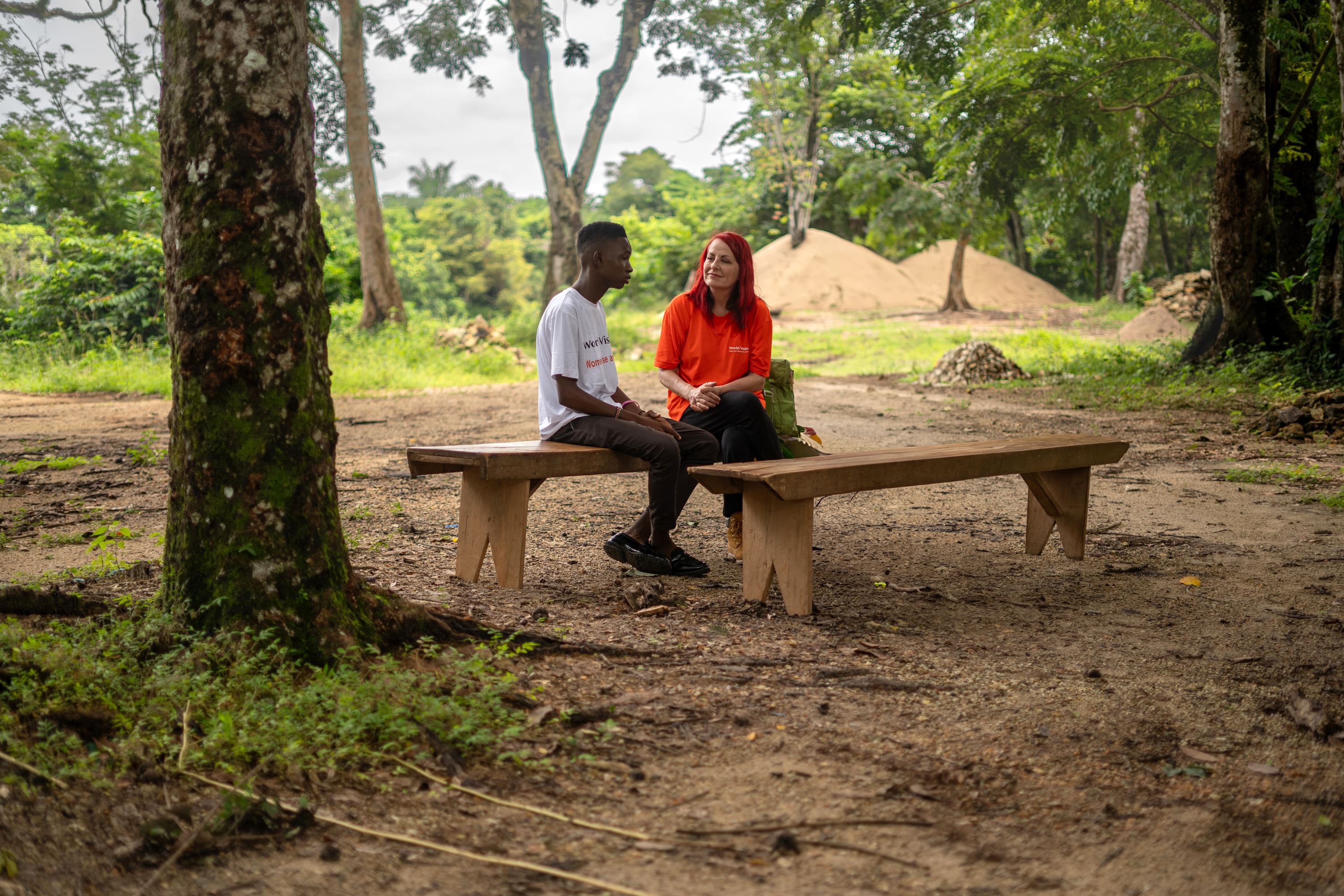 Carrie Grant in conversation with a girl in Sierra Leone