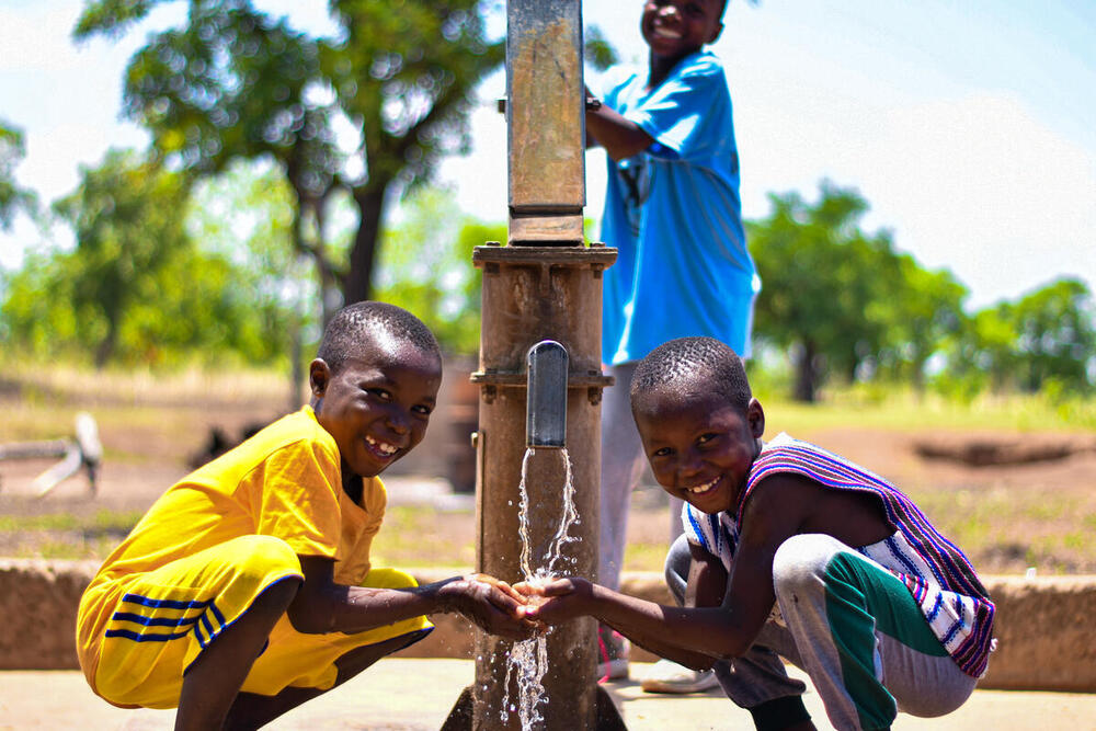 Happy children using their new borehole Ghana