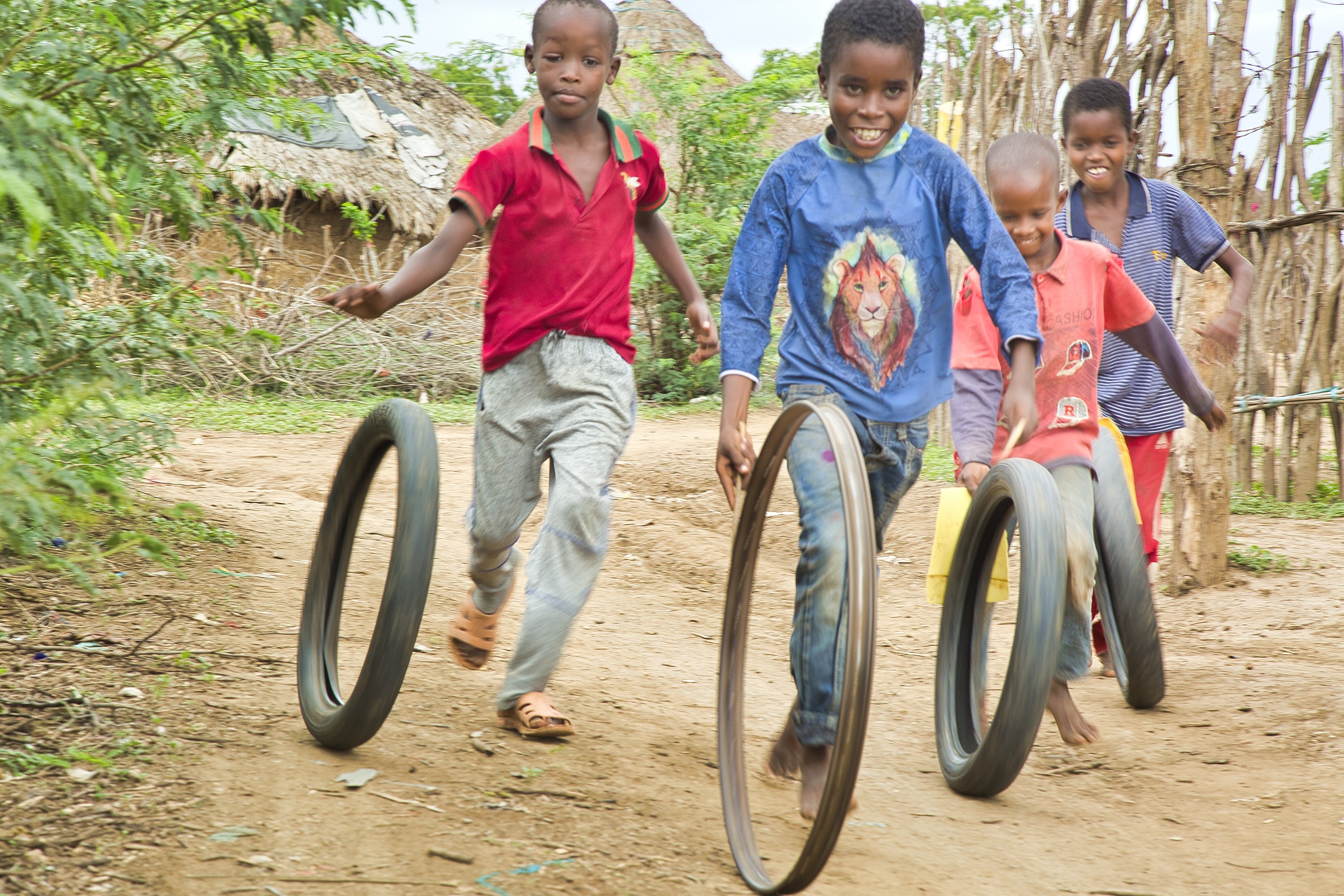 Children playing with old tyres