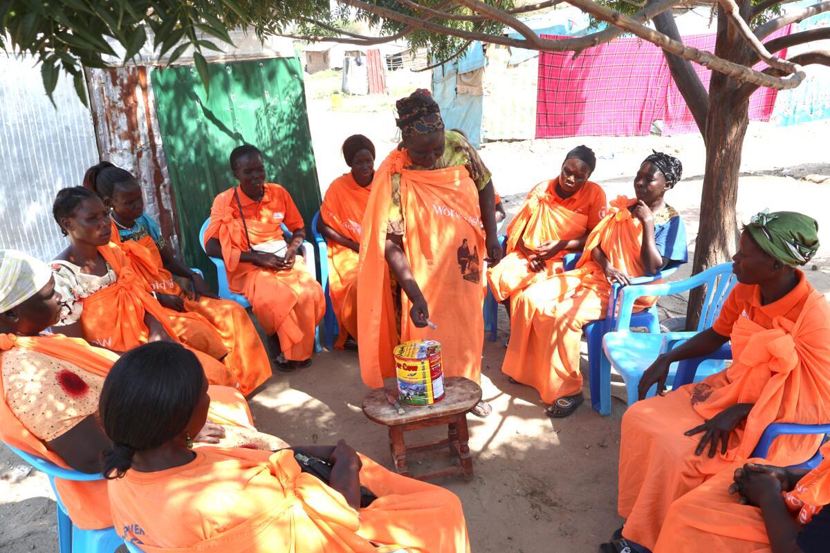 Group of women pooling the proceeds of their sale