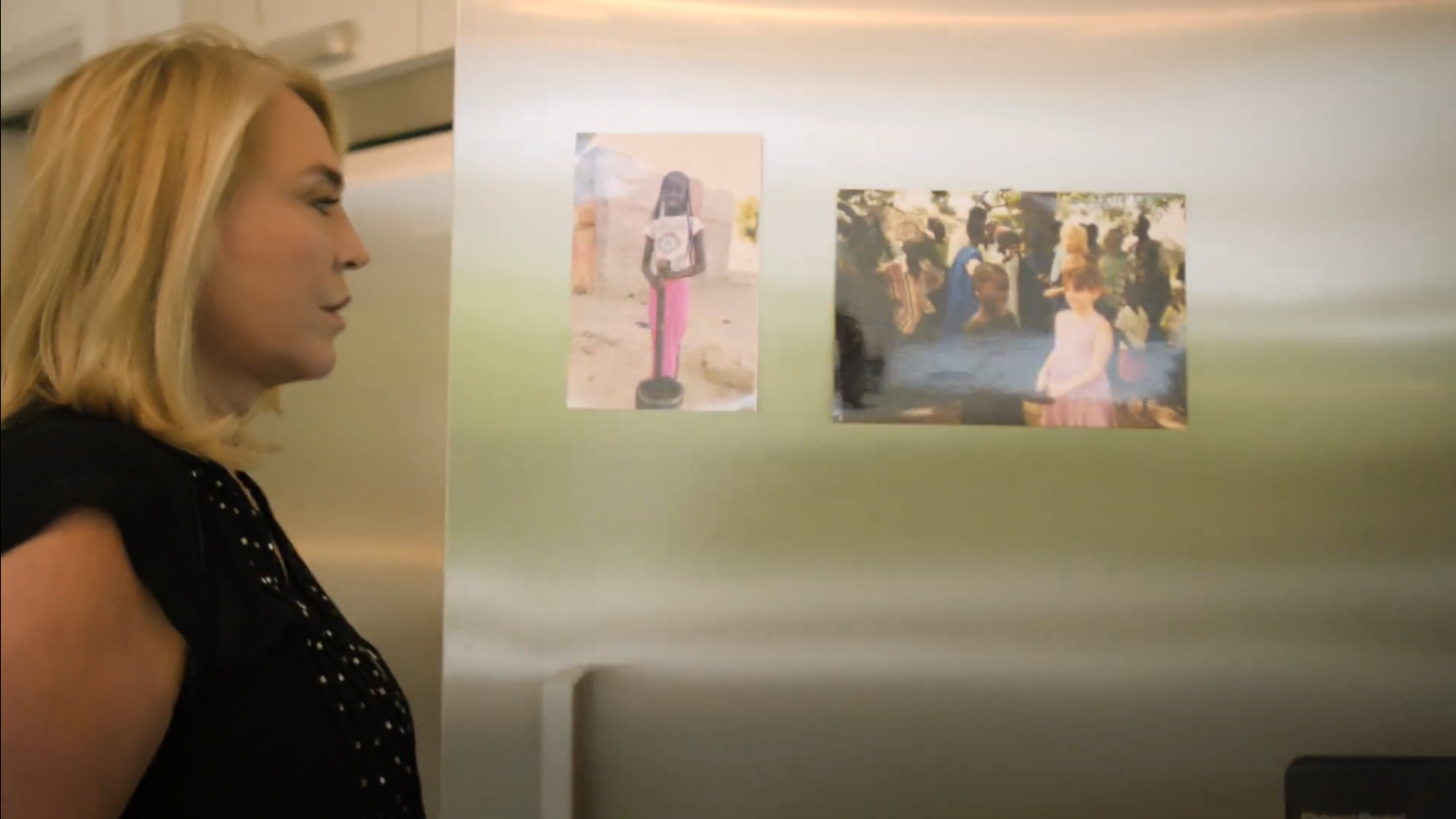 Amanda Redman looks at photos of her sponsored children