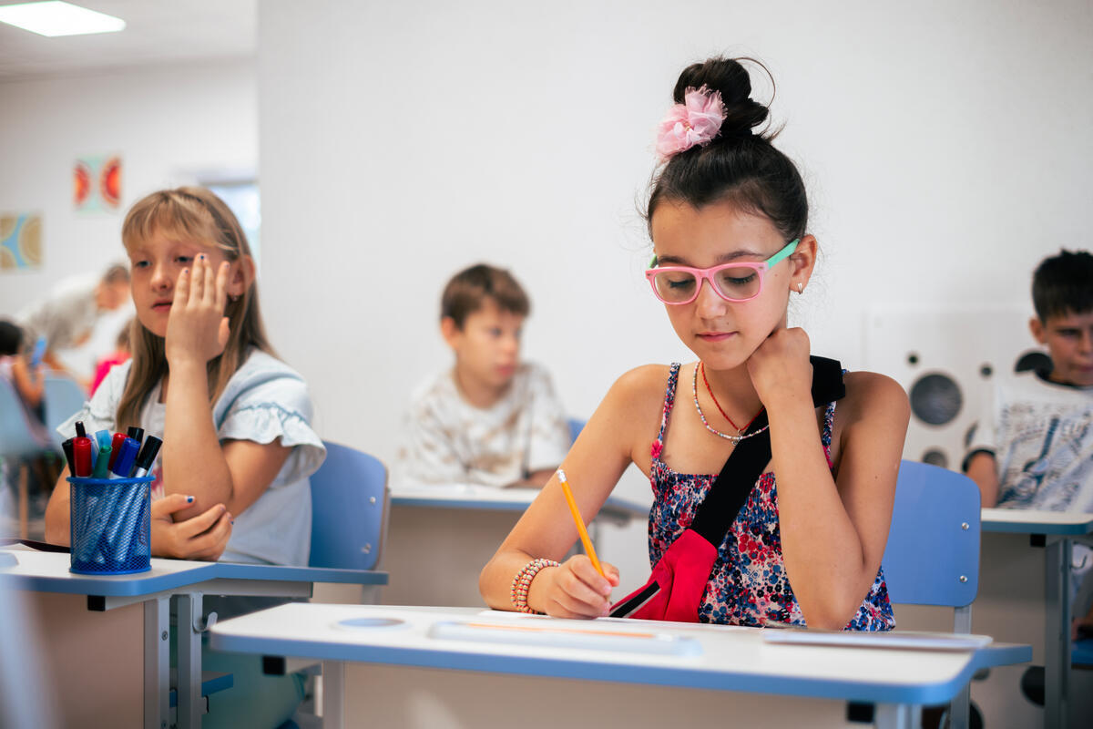Ukrainian school children sit at desks in catch-up classes