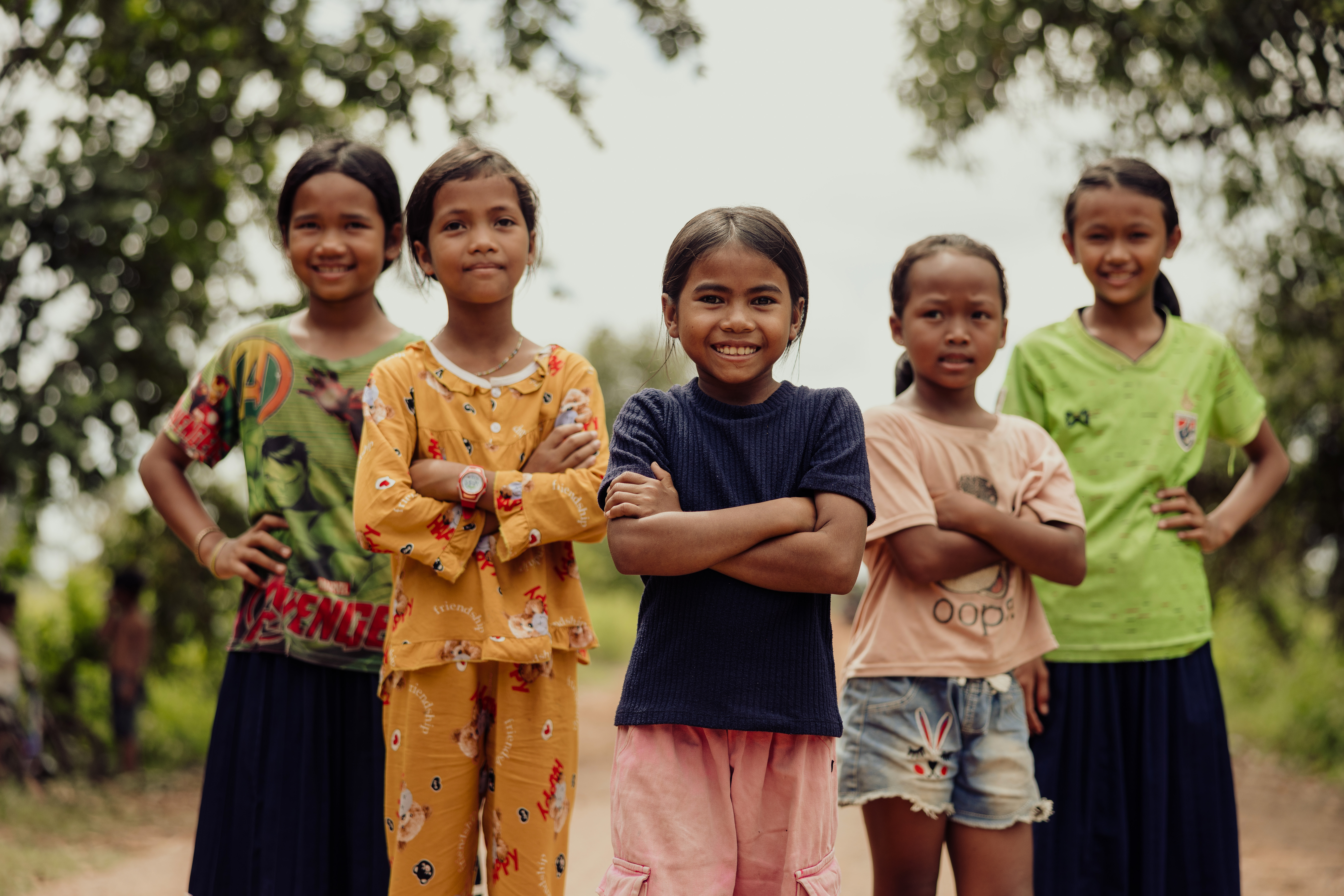 Five young determined girls stood together in Cambodia 