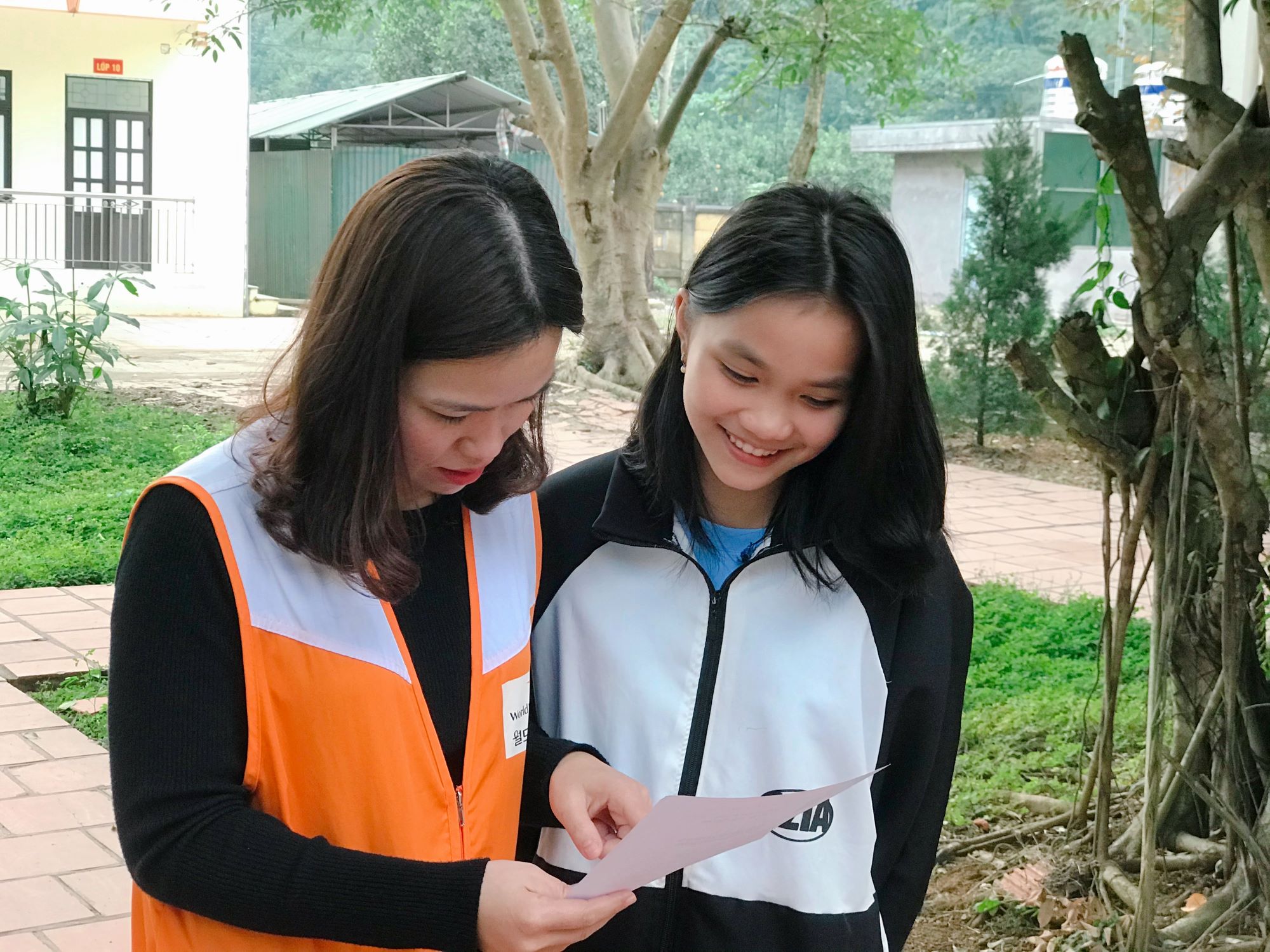 Vietnamese student Thu with World Vision staff member