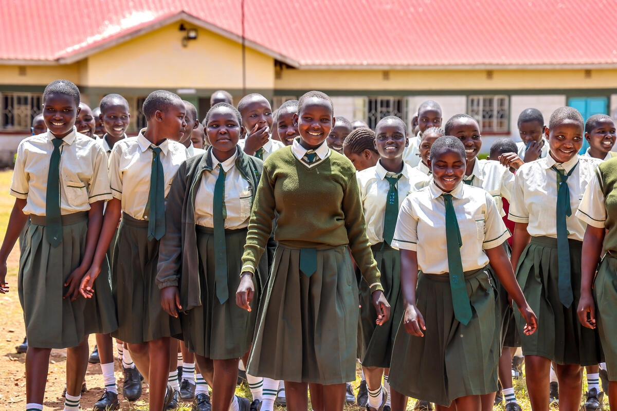 Abigael stands with her classmates outside of their school