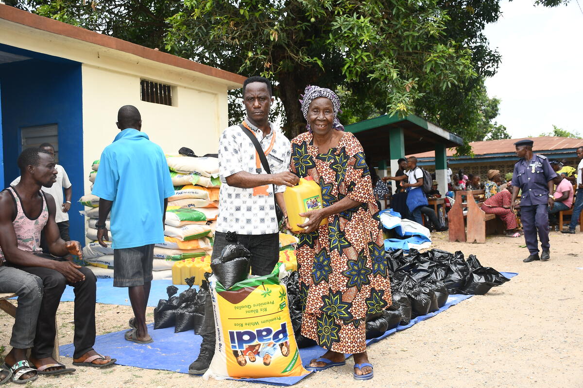 woman and man holding food aid in Sierra Leone