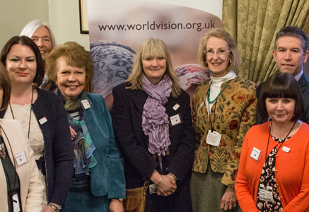 Group of ambassadors from World Vision UK smile in a room together 