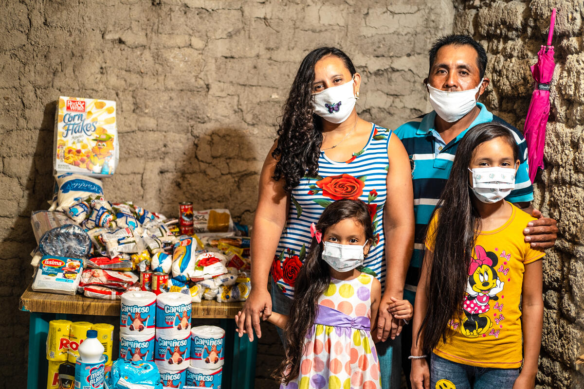 A family wearing masks are provided food in Honduras