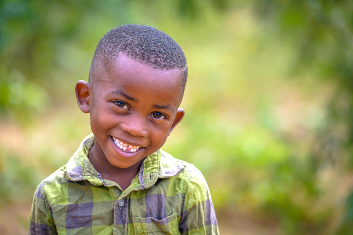 Child in Zambia smiles at the camera