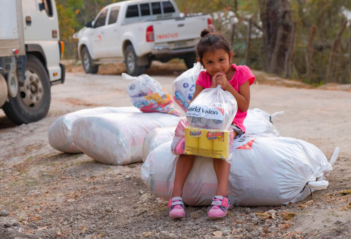 Girl holding a bag of supplies